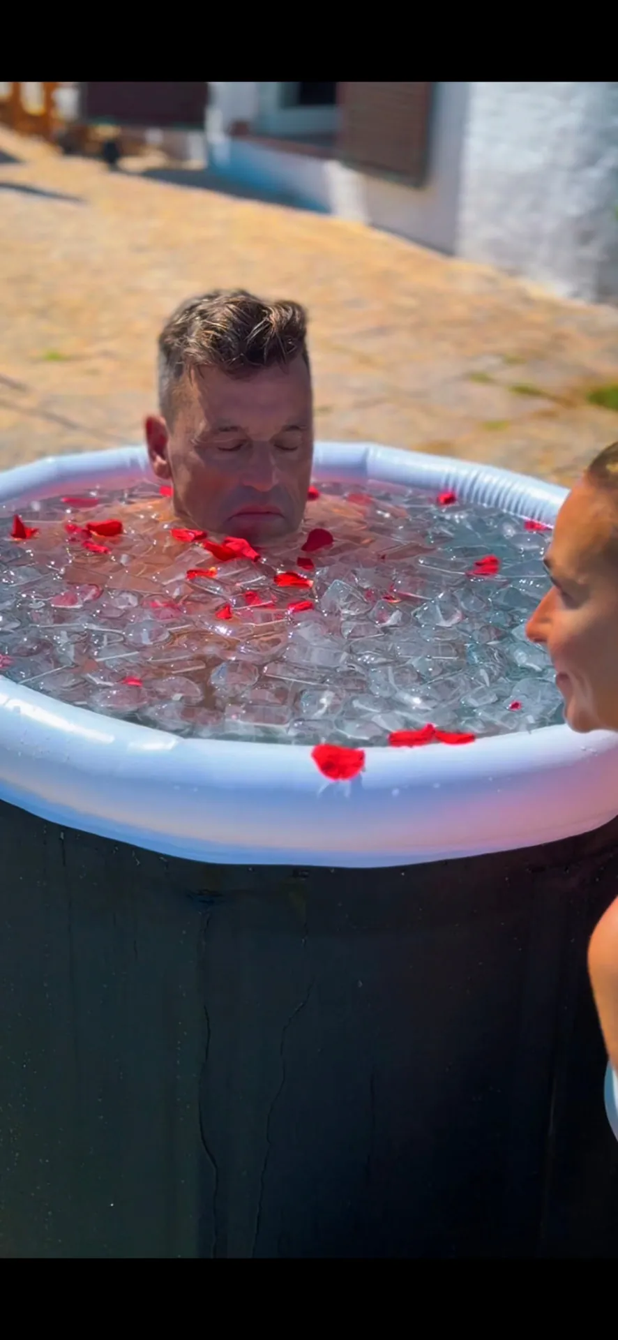 Participant in an ice bath during a guided cold immersion session